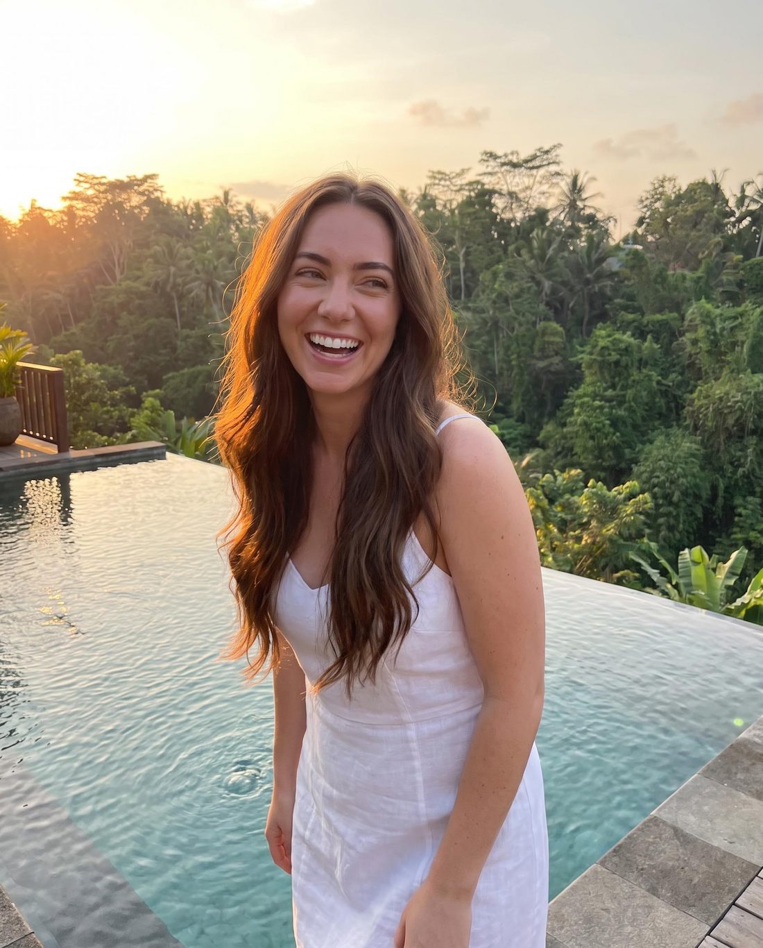 Her AI twin at an infinity pool in Bali at golden hour