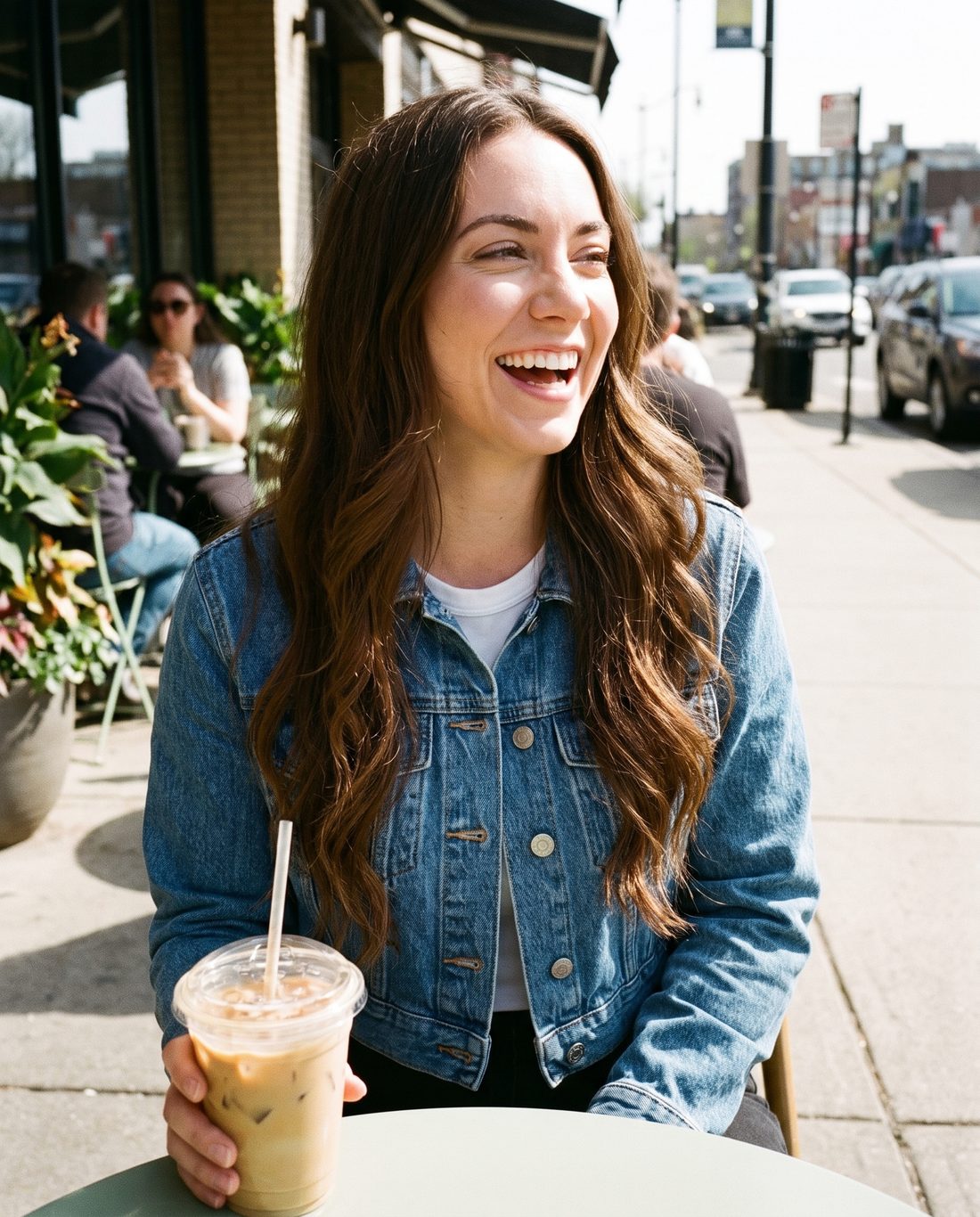 Her AI twin laughing at a sidewalk cafe